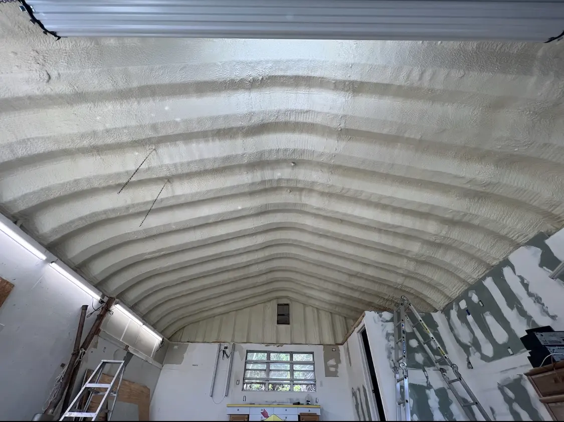 Spray polyurethane foam applied to the underside of a metal roof deck in Woolwich